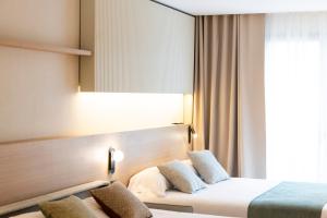Posteľ alebo postele v izbe v ubytovaní Aparthotel Atenea Calabria