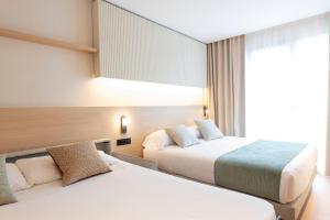 Posteľ alebo postele v izbe v ubytovaní Aparthotel Atenea Calabria