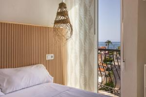 a bedroom with a bed and a balcony at Seaside Serenity in Denia in Denia