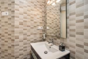 a bathroom with a sink and a mirror at Seaside Serenity in Denia in Denia +13 photos