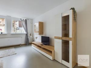 a living room with a tv and a wooden cabinet at Sonnenschein Appartement in Wuppertal in Wuppertal