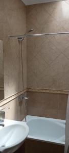 a bathroom with a shower and a sink and a tub at temporary rental Mendoza in Guaymallen