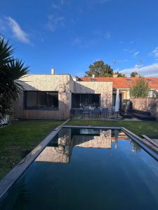 a swimming pool in the backyard of a house at Villa avec piscine, Sainte Marguerite in Pornichet