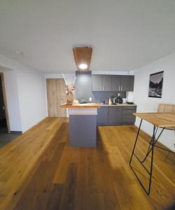 a kitchen with a wooden floor and a counter top at Modernes Apartment in Gondelsheim +2 photos