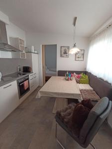 Una sala de estar con una mesa y una cocina. en Ferienhaus Kopp, en Fügen