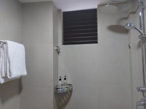 a bathroom with a shower with two bottles on a shelf at Comfy Cool Breeze by eMzaz in Dhiffushi +36 photos