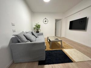 a living room with a gray couch and a table at New 1bdr in Florentin 1 in Tel Aviv