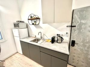 a small kitchen with a sink and a refrigerator at New 1bdr in Florentin 1 in Tel Aviv