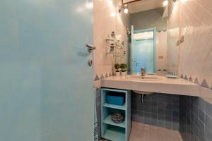 a bathroom with a sink and a mirror at Casa Erica in Stintino