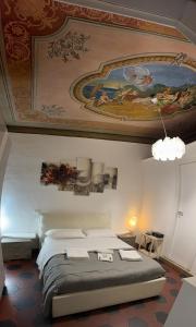 a bedroom with a bed with a painting on the ceiling at Napoleone Suite in Rome
