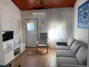 a living room with a couch and a chair at Refugio da Mina in Minas de São Domingos