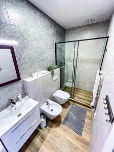 a bathroom with a toilet and a sink and a shower at Skandi in Lubin