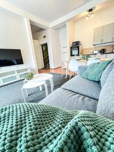 a living room with a couch and a kitchen at Skandi in Lubin +12 photos