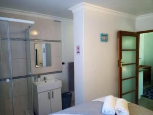 a bathroom with a shower and a sink and a mirror at Memories Vaaldam in Denysville +55 photos
