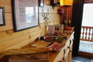 a counter with bread and bowls of food on it at Chalet Le Panicaut in Levassaix