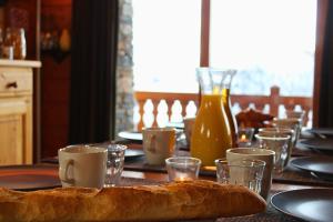 a table with a loaf of bread on it at Chalet Le Panicaut in Levassaix