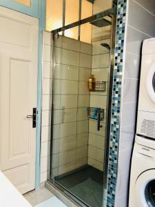 a shower with a glass door in a bathroom at Appartement Plage Malo les bains avec confort in Dunkerque