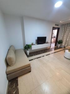 a living room with a couch and a flat screen tv at Dar Kmar 2 in Tunis