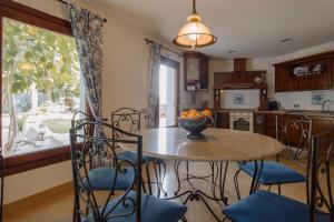 a kitchen with a table and chairs with a bowl of oranges on it at Villa Bora Montiboli by Buccara in Villajoyosa