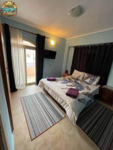 a bedroom with a bed and a large window at The Island in Sharm El Sheikh
