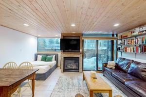 a living room with a couch and a fireplace at Telluride Lodge 324 in Telluride