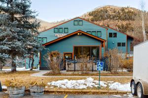 a blue house with a car parked in front of it at Telluride Lodge 324 in Telluride