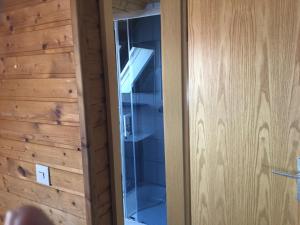 a glass door in a room with a wooden wall at Kulisse Apartments in Günzburg