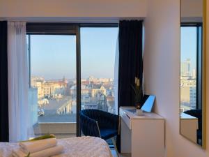 a room with a bed and a window with a view at URBAN APARTMENTS GLOBAL PREMIUM 8th floor no 16, Free Garage, Self Check-in, No Deposit in Katowice