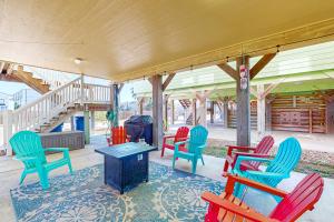 a group of colorful chairs sitting on a porch at Lonestar LegaSea in Port Aransas