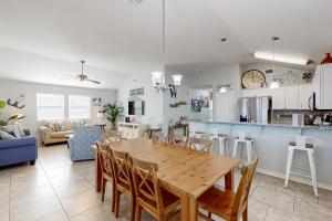 a kitchen and living room with a wooden table and chairs at Lonestar LegaSea in Port Aransas