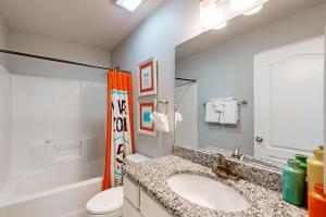 a bathroom with a sink and a toilet at Lonestar LegaSea in Port Aransas +17 photos