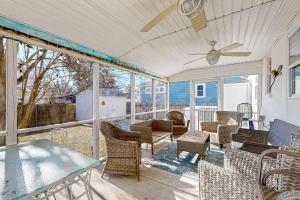 a patio with chairs and tables and a ceiling fan at Ann Acres --- 21069 Elizabeth Ave. in Rehoboth Beach