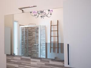 a mirror in a bathroom with a chandelier at Lake Dream 1 Lake View of COMO in Bellano +20 photos