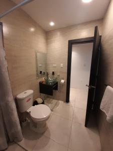 a bathroom with a toilet and a sink at Luxurious house with private beach in Manta
