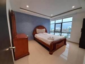 a bedroom with a bed and a large window at Luxurious house with private beach in Manta +56 photos