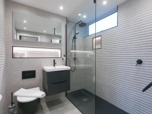 a bathroom with a toilet and a sink and a shower at Louies Loft in St Ives +38 photos