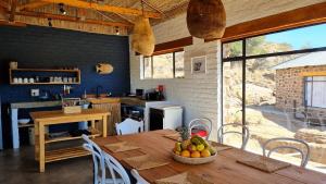 a kitchen with a table with a bowl of fruit on it at Alphen River Lodge in Colesberg