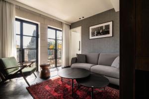 a living room with a couch and a table at מלון רמב"ן ירושלים - קבוצת מחניודה in Jerusalem +73 photos