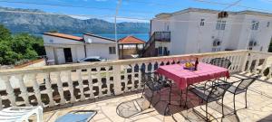 a table and chairs on a balcony with a view at House Karmela in Sućuraj