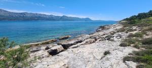 a view of the ocean from a rocky shore at House Karmela in Sućuraj