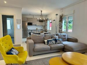 a living room with a couch and a kitchen at Txobe Apartment in Elanchove