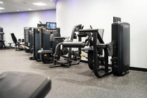 a row of exercise bikes in a gym at East Sussex National Hotel, Golf Resort & Spa in Uckfield