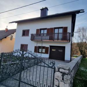 a white house with a fence in front of it at Holiday home in Lokve, Croatia 47707 in Lokve