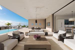 a living room with white furniture and a pool at Apes Hill Barbados Golf and Resort Community in Saint James