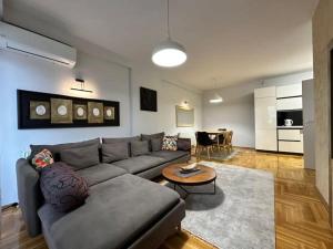 a living room with a couch and a table at Large Apartment in Pristina