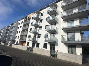 an apartment building with balconies on the side of it at Apartament Luxe z bezpłatnym parkingiem podziemnym in Koszalin