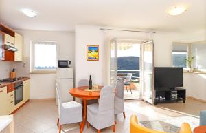 a kitchen and dining room with a table and chairs at Seaview Apartment Bojan Rabac in Rabac +20 photos