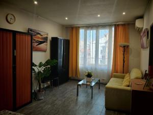 a living room with a couch and a table at Hostel-Élisée-Perpignan in Perpignan