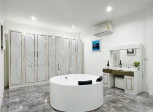 a white bathroom with a tub and a sink at Secret Villa Private 4BR with Pool and Cinema in Amphoe Koh Samui