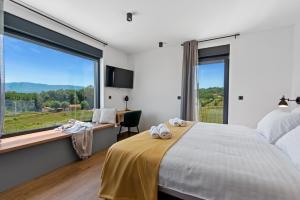 a bedroom with a bed and a large window at Villa Ani for 8 people near Labin Rabac with private pool and children playground in Potpićan